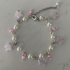 Handcrafted dainty silver/pink coloration charm bracelet with a variety of beads/charms ~ varieties include glass, pearlized & metal charms/beads.  Great gift to give or for yourself!  Fun to wear or give!  Perfect for daughter or granddaughter!  Adjustable length up to 8.5" Each bracelets is unique & individually handcrafted. Coquette Charm Bracelet, Diy Jewelry Unique, Bracelet In Silver, Diy Bracelets Patterns, Diy Bracelet Designs, Metal Charms, Jewelry Accessories Ideas, Kawaii Accessories, Beads Charms