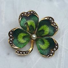 a four leaf clover brooch with pearls