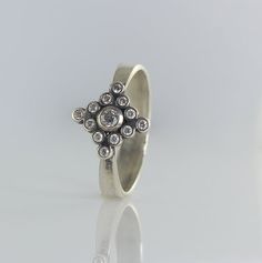 a silver ring with diamonds on it