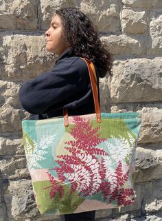 This gorgeous oversized tote bag was made from reclaimed mid-century curtains in absolutely beautiful colors. (It was hard to capture the colors because of lighting, but the close-up pictures are the most accurate.) The simple lines highlight the unusual design and nubby texture of the fabric. The bag has two large inside pockets - one zipper pocket and one slip pocket. The 30 inch leather straps are reinforced for strength. The lining is a durable upholstery fabric chosen to complement the main fabric and give the bag shape and strength. At the same time, the bag is light, easy to carry and could be folded down if you wanted to put in luggage or store away.   Large enough to use for shopping, overnight bag or beach bag. This is a one-of-a-kind piece designed and constructed in our studio. Retro Upcycled Tote Bag, Upcycled Green Tote Shoulder Bag, Upcycled Green Tote Bag, Mid Century Curtains, Oversized Tote Bag, Oversized Tote, Close Up Pictures, Unusual Design, Overnight Bag