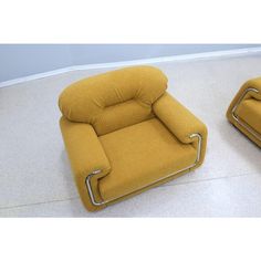 two yellow recliners sitting on top of a white floor next to each other