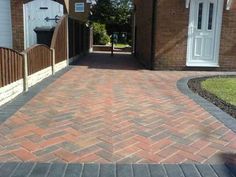 a brick walkway leading to a house