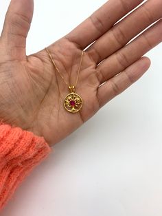 Ruby Tree of Life Pendant set with a Created Ruby in top grade, perfect diamond cut & intense red color.Gold Vermeil - 18K Gold plating over Solid 925 Sterling Silver.Matching Ring & Earrings - please ask meDetails:• Created Ruby in a flawless clarity• Ruby: 5mm, 0.5 Ct, round cut• Dimensions: Pendant Height 23.5mm, Width 16.5mm• Free Complimentary Chain• 18k Gold VermeilSKU 2849 Diamond-cut Ruby Jewelry As Gift, Diamond-cut Ruby Jewelry For Gifts, Diamond Cut Ruby Jewelry As Gift, Red Gold Plated Necklace, Gold Ruby Birthstone Jewelry, Red Gold Plated Round Pendant Jewelry, Red Gold-plated Round Pendant Jewelry, 14k Gold Red Engraved Jewelry, Red 14k Gold Engraved Jewelry