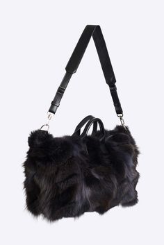 This medium duffle is made in soft upcycled fox pieces with leather trim, polyester lining and comes with a removable leather shoulder strap.Color and style of fur may vary slightly due to variations in the upcycling process. This item is made to order. Please allow 10 – 20 business days for International delivery. School Wishlist, Expensive Things, Refined Fashion, Miscellaneous Items, Fur Bag, Buy Bags, Magda Butrym, Pretty Bags, Sustainable Fabrics