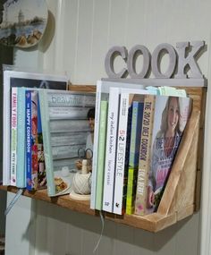 a book shelf with books on it and the word cook spelled in large letters above them