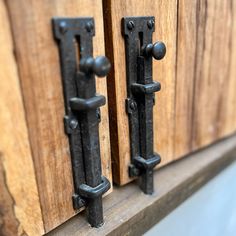 two wooden doors with metal handles on them