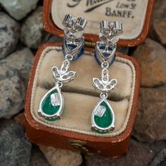 This fantastic pair of dangle earrings are each accented with one (1) pear mixed cut natural sapphire set into a three-prong setting, one (1) pear mixed cut natural emerald set into a three-prong setting and six (6) round brilliant cut diamonds set into a shared prong style setting. The earrings measure 26.0mm in length and 6.5mm wide. The earrings are finished with friction backs for pierced ears. Emerald Pear-shaped Fine Jewelry Earrings, Pear-shaped Emerald Earrings For Anniversary, Fine Jewelry Emerald Pear-shaped Earrings, Formal Teardrop Multi-stone Earrings, Formal Multi-stone Teardrop Earrings, Pear-shaped Emerald Earrings Fine Jewelry, Pear-shaped Multi-stone Formal Jewelry, Fine Jewelry Pear-shaped Gemstone Earrings, Elegant Multi-stone Pear-shaped Jewelry