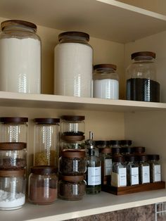 several jars and containers are on the shelves