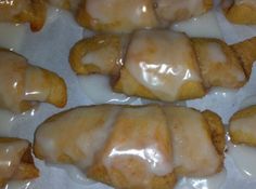 glazed doughnuts sitting on top of parchment paper in the shape of chicken wings