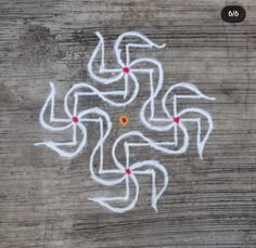 a wooden surface with some white writing on it and red dots in the shape of arrows