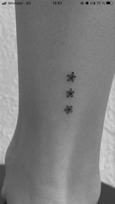 four leaf clovers tattoo on the back of the foot, which has three smaller shamrocks