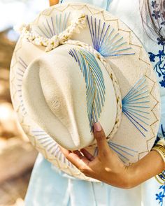 The wait is over! This hat is Ready to Ship and your order will be processed and shipped within 3-7 business days. Items with embroidery customization will be shipped within 2 weeks. Dyed White Palm Wide Brim Hat with Blue/Gold Feather Design Custom designed and hand made hats by artisans in San Jose Del Cabo, Mexico. These hats are one size fits most with an elastic band inside to add comfort and fit for all head sizes. Please note, all hats come with natural braid unless custom braid is purcha Shoes Makeover, Cowboy Hat Crafts, Boho Chic Hats, San Jose Del Cabo Mexico, Cowboy Hat Design, Hat Burning, Hat Bar, Custom Made Hats, Hat Aesthetic