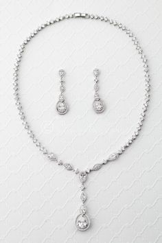 Add a touch of vintage flair to your special occasion ensemble with this radiant necklace of CZ jewels. This delicate necklace set is appropriate for weddings or any special occasion. It is 16 inches long with a locking clasp. the drop is 2 inches long. The earrings are post backs and 1 and 5/8 inches long. Grade AAA cubic zirconia, rhodium or rose gold plated, nickel and lead free. Bridal Accessories Headpieces, Chunky Silver Necklace, Bride Jewelry Set, Wedding Necklace Set, Diamond Jewelry Set, Sterling Silver Bead Bracelet, Silver Bead Bracelet, Necklace Diamond, Wedding Accessories Jewelry