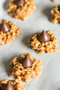 cookies with chocolate on top sitting on a sheet of paper