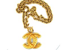 Specifications:Designer: CHANELTotal Weight: 140 GramsPendant CC Measurements: ~2.25" x 1.9"Chain Length: ~30" with bailStamped: "CHANEL "Made in France"Condition: PreownedGold Plated Metal Pendant Jewelry With Gold-tone Logo Plaque, Metal Pendant Necklace With Gold-tone Logo Plaque, Vintage Gold Necklace With Gold-tone Logo Plaque, Formal Gold Chain Necklace With Logo Charm, Gold-tone Logo Plaque Pendant Necklace, Vintage Necklace With Logo Charm For Formal Occasions, Gold Jewelry With Logo Charm For Collectors, Vintage Pendant Necklace With Logo Charm, Formal Gold-tone Logo Plaque Pendant Jewelry