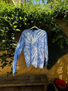 Embrace the perfect blend of comfort and style with this Handmade Blue & White Tie-Dye Cotton Shirt! Crafted on a high-quality, size Large Gildan tee, this shirt is made from 100% soft cotton, ensuring a comfortable fit for any occasion. Key Features: Vibrant Blue & White Tie-Dye: Each shirt is hand-dyed, making every piece truly one-of-a-kind. The eye-catching pattern is perfect for standing out at festivals, beach days, or casual outings. Size Large (Gildan): This unisex tee fits true to size and is made by Gildan, known for its durable and soft cotton fabric. Versatile & Stylish: Whether you're looking to add a boho vibe to your wardrobe or searching for the perfect gift, this tie-dye shirt is a great choice. Care Instructions: To maintain the vibrant colors, wash in cold water and air Blue Relaxed Fit Comfortable T-shirt, Spring Tie Dye T-shirt For Loungewear, Blue Washed T-shirt For Spring, Comfortable Blue Cotton T-shirt, Sporty Acid Wash Tops For Loungewear, Sporty Washed Blue Relaxed Fit Top, Casual Tie Dye T-shirt For Loungewear, Blue Crew Neck Comfortable Tops, Relaxed Fit Acid Wash Cotton Tops