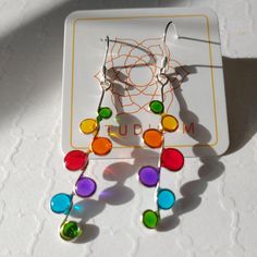 rainbow stained glass resin dot earrings, stained glass earrings with silver wire Handmade in Richmond, VA (RVA), these delicate resin earrings glow in the colors of the rainbow. The transparent bubbles shine when they catch the light, while the silver wire mimics the look and feel of stained glass panes. These earrings would be perfect for a day out on the town or a sun filled picnic in the park. These are great for: - teacher gifts - gifts for artists in your live - gifts for friends I use silver colored artistic wire to bend the bubble shapes. Then I carefully apply the resin to create the imitation stained glass effect. The process for making these earrings takes about 48 hours but the outcome is well worth the effort. Length: 2 inches These earrings use fish hook type ear wires but fe Rainbow Nickel-free Earrings For Gifts, Nickel-free Rainbow Earrings Gift, Nickel-free Rainbow Earrings For Gift, Colorful Hypoallergenic Dangle Jewelry, Rainbow Sterling Silver Nickel-free Earrings, Nickel-free Rainbow Sterling Silver Earrings, Rainbow Nickel-free Drop Earrings, Nickel-free Rainbow Drop Earrings, Stain Glass Jewelry