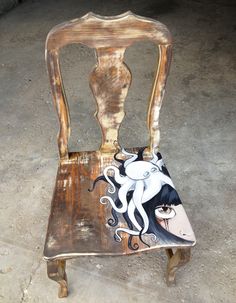 a wooden chair with an octopus painted on it