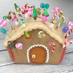 a gingerbread house with candy canes and lollipops on it's roof