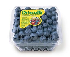 a plastic container filled with blueberries on top of a white table