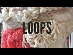 the words loops are written in black on top of white and red yarns hanging from hooks