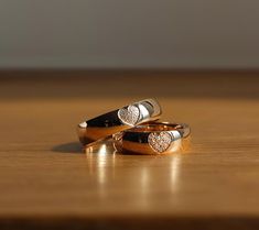 two wedding rings sitting on top of each other