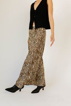 add a feisty touch to any outfit with this jaw-dropping leopard maxi skirt. guaranteed to turn heads, it has a silky, fitted silhouette with a stretchy elastic waistband. the perfect leopard printed skirt to dress up or down, season after season. leopard // maxi length, elastic waistband, scallop trim waist detail, bow detail paired with our good graces vest // black model is 5'8" + wearing a small measurements are approximate + taken while laying flat small : waist 26” length 37.5” medium : wai Maxi Length Bottoms With Elastic Waistband For Fall, Fall Maxi Length Bottoms With Elastic Waistband, Wide Leg Maxi Skirt For Fall Day Out, Fall Wide Leg Maxi Skirt With Elastic Waistband, Fall Maxi Skirt With Elastic Waistband And Wide Leg, Leopard Maxi Skirt, Skirt To Dress, Leopard Maxi Skirts, Trim Waist