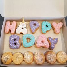 a box filled with lots of donuts covered in frosting