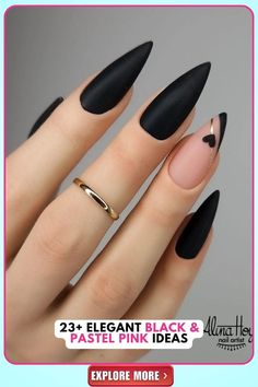 Stiletto-shaped black matte nails with a pastel pink nude base, adorned with a delicate heart detail, ideal for bold fashion statements and romantic settings, exuding edginess and femininity. Matte Nails Design Black, Matte Black And Gold Nail Ideas, Short Steletoes Nails, Black And Pastel Nails, Nude Black Nail Designs, Black Nails Ideas Matte, Cute Acrylic Nails Black, Black And Nude Nails Simple, Black And Neutral Nails