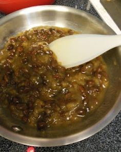 a spoon is stirring some food in a pan