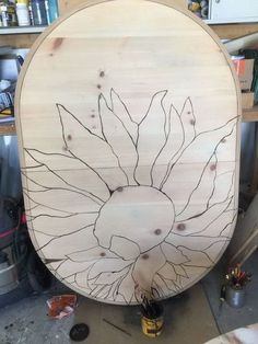 a large wooden object sitting on top of a workbench in a workshop area