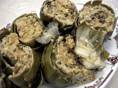 some artichokes are sitting on a plate