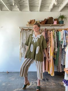 Vintage Green and Yellow Striped Tunic. A head-turning tunic made from a thick green and yellow striped cotton. with white stitched details at the neckline and along the large front pockets. Decal stitched into the back as well. Unique, fun, and easy to wear! Unmarked materials, feels like thick cotton. Unmarked size, fits many due to loose cut. Approx. Measurements: Underarm to underarm: 26" Length: 28" Green Tunic For Spring Daywear, Oversized Green Tunic For Spring, Green Relaxed Fit Tunic For Summer, Oversized Green Cotton Blouse, Bohemian Striped Cotton Tops, Oversized Olive Cotton Top, Relaxed Fit Cotton Tunic For Spring, Vintage Cotton Tunic Top, Green Tops With Striped Collar And Relaxed Fit