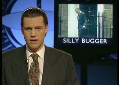 a man in a suit and tie is talking to someone on the television screen that says silly bugger