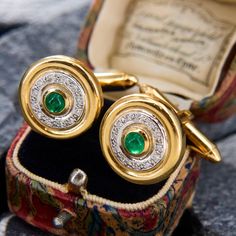 These dapper cufflinks each have a central round emerald cabochon in a gold bezel, surrounded by a circle of single cut diamonds, and an outer edge of high polished gold. The bullet-style closures are in excellent condition. The cufflinks are crafted in 14k yellow gold. Luxury Antique Gold Cufflinks, Luxury Hallmarked Yellow Gold Cufflinks, Luxury Yellow Gold Round Cufflinks, Emerald Cabochon, Diamond Cufflink, A Circle, Cufflinks, Diamond Cuts, Emerald