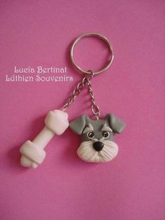 a keychain with a dog and a bone on it