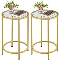 two round glass tables with gold metal legs and flowers on each end table, both side by side