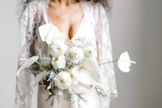 a bride holding a bouquet of flowers in her hands