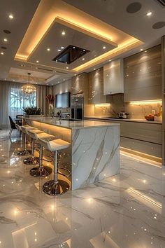 an elegant kitchen with marble counter tops and bar stools in the center, lighted by recessed lighting