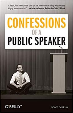 a man sitting on the ground in front of a podium with a sign that says,'confessionss of a public speaker '