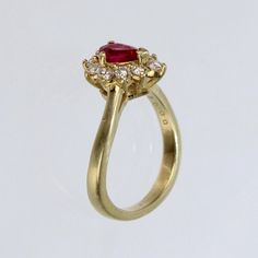 A wonderful cocktail ring by Kurt Wayne.  In 18K yellow gold with a half-twist to the shank. The shank supports a gallery with a central pear-cut ruby and 10 small round cut diamonds.   A high-level ring from the famous New York jewelry designer!  Marked to the shank 750 for 18k gold fineness and with a conjoined KW for Kurt Wayne.  Ring Size: ca. 5 1/2  Dimensions reference the ring size and are not specific to the ring itself. Teardrop Yellow Gold Ruby Ring For Wedding, Gold Ruby Ring Pear-shaped, Yellow Gold Ruby Ring With Prong Setting, Yellow Gold Pear-shaped Ruby Ring, Pear-shaped Ruby Ring With Diamond Halo Setting, Pear-shaped Ruby Ring With Diamond Halo, Pear-shaped Ruby Ring In Yellow Gold With Prong Setting, Pear-shaped Ruby Ring In Gold, Pear-shaped Brilliant Cut Yellow Gold Ruby Ring