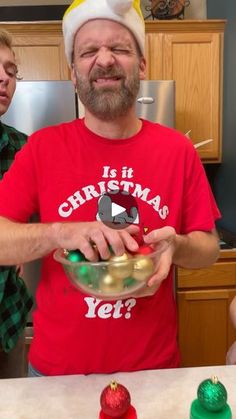 a man in a santa hat is holding a bowl