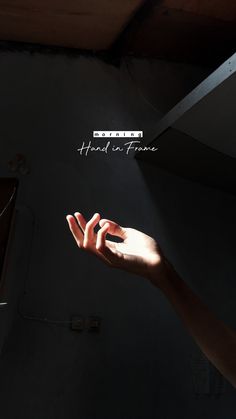 two hands reaching towards each other with the words hand in frame above them on a dark background