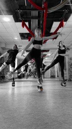 people are doing tricks on their skateboards in a dance studio with red ribbons hanging from the ceiling