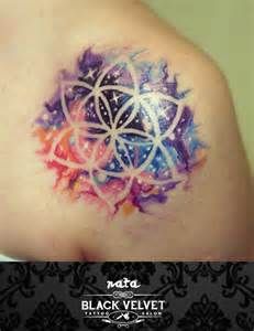 a colorful tattoo on the back of a woman's shoulder