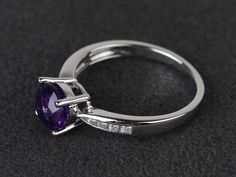 Welcome to my shop, you can find many beautiful gemstone jewelry here, and you also can ask for customized service. Main Stone: natural amethyst, round cut, measures 7X7mm, weight about 1.23 carats.Accent Stones: czMetal: 925 sterling silver plated with rhodium. I also can provide metal options such as 14k solid yellow/white/rose goldSetting: prong settingmore rings: https://www.etsy.com/shop/XCjewelryStudio?ref=hdr_shop_menuIt's a perfect gift for the person who was born in February (Birthstone Purple Diamond Ring With Halo Setting, Purple Brilliant Cut Rings For Promise, Purple Amethyst Ring With Round Cut And Accent Stones, Fine Jewelry Purple Sapphire Ring With Round Cut, Purple Brilliant Cut Round Sapphire Ring, Sterling Silver Amethyst Ring With Brilliant Cut For Promise, Amethyst Ring In Brilliant Cut Sterling Silver For Promise, Brilliant Cut Amethyst Ring In Sterling Silver For Promise, Purple Sapphire Ring With Center Stone In Round Cut