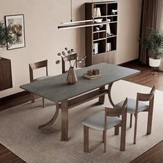 a dining room table and chairs in front of a window