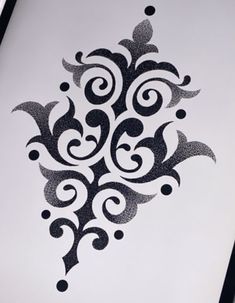 an artistically designed piece of paper with black and white designs on it's surface