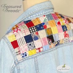 the back of a woman's jean jacket with patchwork on it