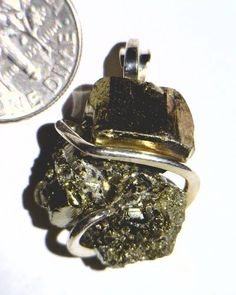 37.61ct Natural Pyrite Druzy in Sterling Silver Wire Wrap Pendant   37.61 carats total weight click picture to enlarge click picture to enlarge click picture to enlarge click picture to enlarge Description CHECK OUT OUR OTHER AUCTIONS & EBAY STORE! Size 24 mm by 17 mm by 12 mm Total Weight 37.61 carats   Fantastically Done Natural Pyrite Druzy! This pyrite Crystal is beautiful and beautifully set in a hand forged Sterling Setting! This is a great find don't miss it!!  Very unusual piece! According to wikipedia:   The mineral pyrite, or iron pyrite, is an iron sulfide with the formulaFeS2. This mineral's metallic luster and pale-to-normal, brass-yellow hue have earned it the nickname fool's goldbecause of its resemblance to gold. The color has also led to the nicknames brass, brazzle and Br Pyrite Jewelry, Artisan Jewelry Necklaces, Iron Pyrite, Wire Wrap Pendant, Pyrite Crystal, Metallic Luster, Sterling Silver Wire Wrap, Handcrafted Artisan Jewelry, Wrapped Pendant